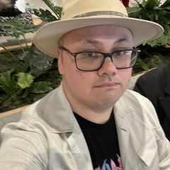 Me at the airport, wearing his newly-purchased hat. The picture is a little blurry.