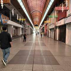 My brother walking through a closed-up shōtengai near where we stayed. All of the shops have their shutters down.
