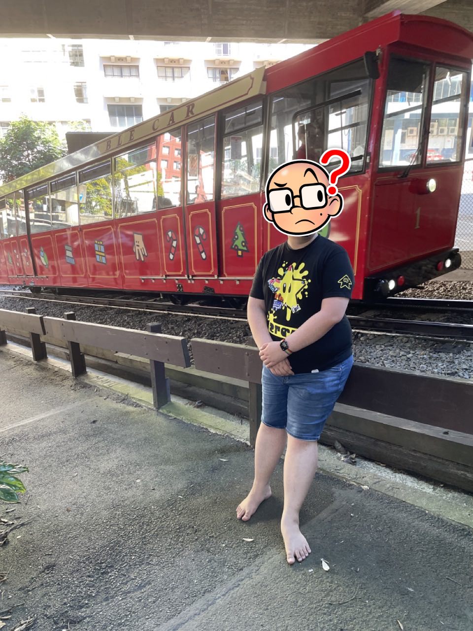 Feets stands in front of the Wellington cable car as it moves along the track