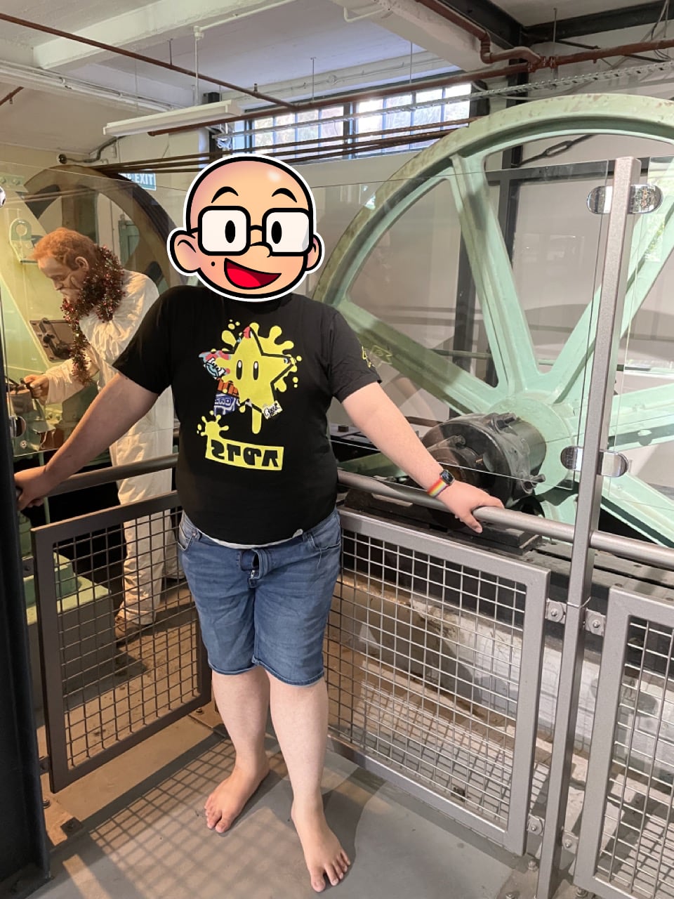 Feets stands in front of the original wheel that pulled the cable car