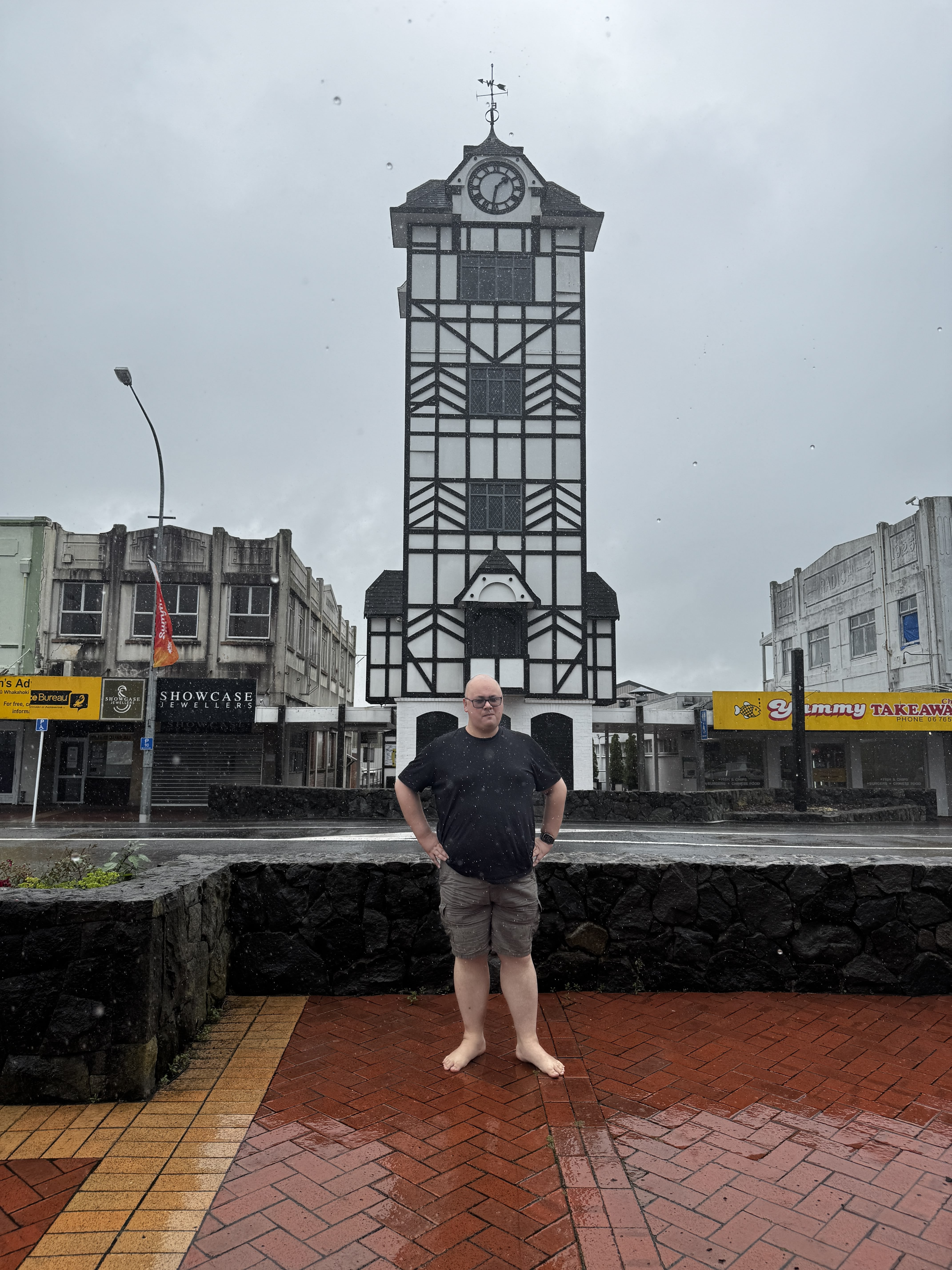 Feets standing in front of the clock tower in Stratford, taken on the way to New Plymouth. The lens was covered in rain drops.