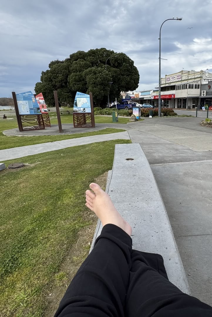 Me standing in front of a large tree on Marine Parade.